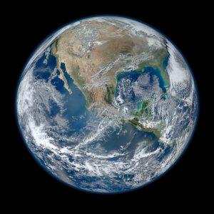 A NASA-generated, high definition image of the Earth from space primarily showing North and Central America, the Gulf of Mexica, the Pacific Ocean, and swirling clouds.